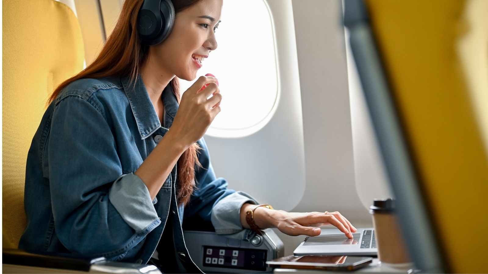 Woman using tech on a plane