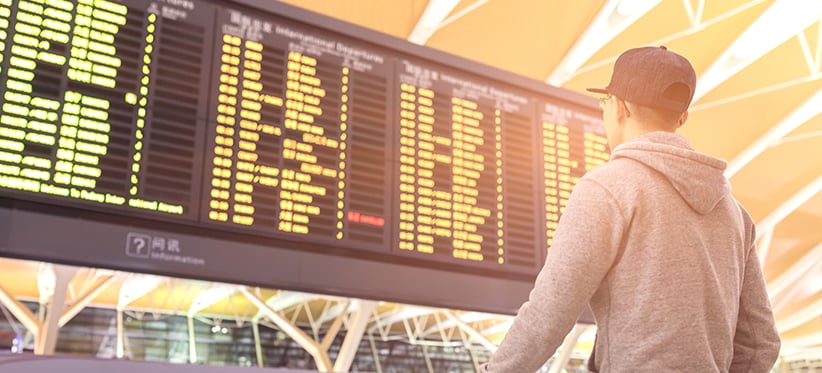 Man looking at Flight Information Display